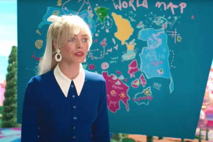 Margot Robbie in front of map in Barbie